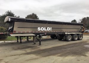 Live Bottom Trailer. 2011 Trail King Red River Series. Model OLB 336 Tri axle with two fixed axles and one lift tag axle. GVRW for the trailer is 84'250 lbs. It has air side suspension, aluminum wheels, tires 24.5, tarp and steel body composition. 40' 7" length x 9' 2' high x 102 width. Capacity; 32 cubic yards. 