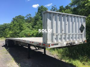 Aluminum flatbed semi trailer. 2004 Manac 48 foot trailer in great condition. Trailer for sale as seen with added bulkhead, new tool box and two dunnage racks. Has newer air tank and tires that are at about 70% - 80% tread. Great trailer ready to work. Unladen weight 9050 lbs.