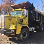 1986 Kenworth Dump Truck. Model C510. Big cam 400 Cummins diesel engine. 376,040 metered miles. Eight speed Eaton Fuller transmission with low, low. Heavy duty rear axle and springs with a 5.38 gear ratio. Approximately 24 yard Fruehauf bathtub body. Three stage engine brake