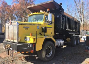 1986 Kenworth Dump Truck. Model C510. Big cam 400 Cummins diesel engine. 376,040 metered miles. Eight speed Eaton Fuller transmission with low, low. Heavy duty rear axle and springs with a 5.38 gear ratio. Approximately 24 yard Fruehauf bathtub body. Three stage engine brake