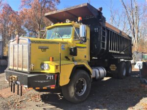 1986 Kenworth Dump Truck. Model C510. Big cam 400 Cummins diesel engine. 376,040 metered miles. Eight speed Eaton Fuller transmission with low, low. Heavy duty rear axle and springs with a 5.38 gear ratio. Approximately 24 yard Fruehauf bathtub body. Three stage engine brake