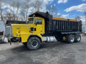 1986 Kenworth Dump Truck. Model C520 has a big cam 315 Cummins motor turned up to 475 hp with a low flow coolant system. 376,125 metered miles. Eight speed Eaton Fuller transmission with low, low. 22,000 lb. front axle. Double frame. Heavy duty 46,000 lb. Rockwell rear axle and Hendrickson heavy duty spring suspension with a 5.29 gear ratio. New bearings and brakes. Three stage engine brake.  75 mph highway speed. Approximate 24 yard 17 foot long Fruehauf bathtub body. GVWR 68,000 lbs. Empty weight 30,000 lbs.