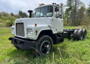 Mack DM600 Cab & Chassis. Double frame. 673 - 6 cylinder diesel engine with turbo and 214,430 miles. Two stick 5 + 4 Transmission with 52K lbs. rears. Good tires all around. Air ride driver seat, air brakes and differential lock. Frame measurement from back of cab to end of frame is 21.4 ft. in.