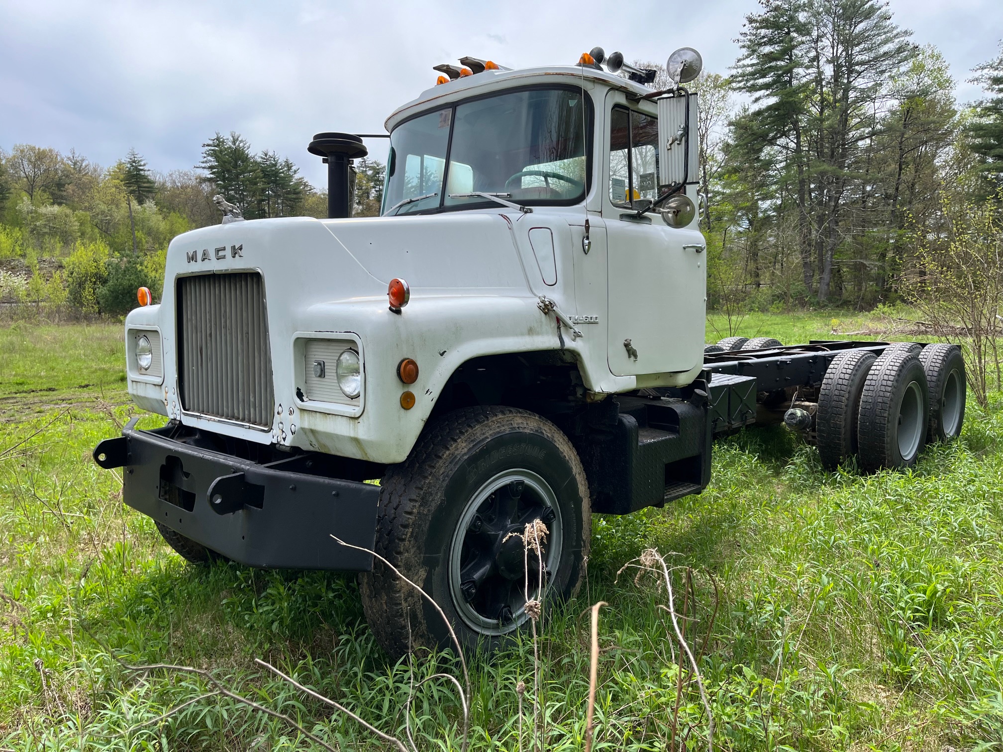Mack DM600 Cab & Chassis. Double frame. 673 - 6 cylinder diesel engine with turbo and 214,430 miles. Two stick 5 + 4 Transmission with 52K lbs. rears. Good tires all around. Air ride driver seat, air brakes and differential lock. Frame measurement from back of cab to end of frame is 21.4 ft. in.
