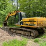 JCB JS220LC Crawler Excavator. A 2007 model (4HKIS) with a 4-cylinder turbocharged 2353 engine has run for 6413 hours and has 172 hp. The machine has a Lemac hydraulic thumb and a 42-inch bucket.  It weighs 22.2 tonnes. Shipping measurements are 31.42 ft in length, 10 ft in height, and 9.83 ft in width outside of tracks. It also comes with heat and A/C. The machine is well-maintained and runs properly.