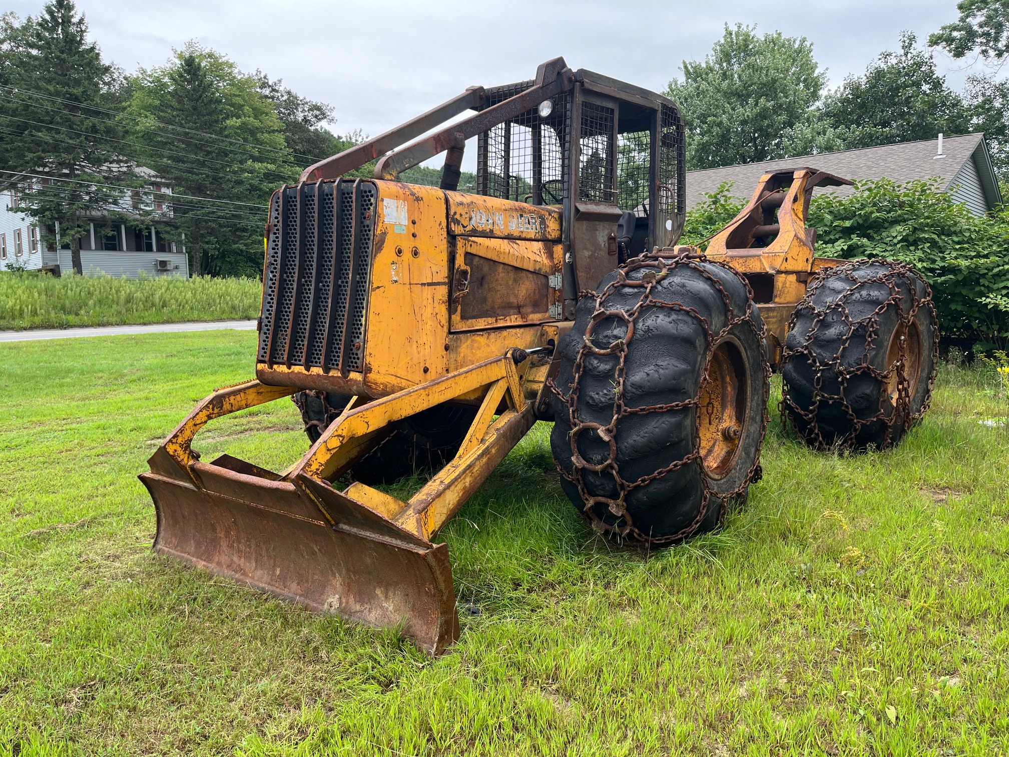 John Deere 640D Log Skidder: 1987 JD 640d cable log skidder with a John Deere 6-414t engine re-sleeved in the early 2000s. It has 28,632 total hours on the machine. The transmission is a power shift with 8 forward and 4 reverse gears. It has articulated frame steering. The foot brake is a week and may need attention. The hand brake works fine. The John Deere 640d logging skidder is chained up! It has an operating weight of 20,180 lbs, a wheelbase of 113 inches, and a 19.2-inch clearance.